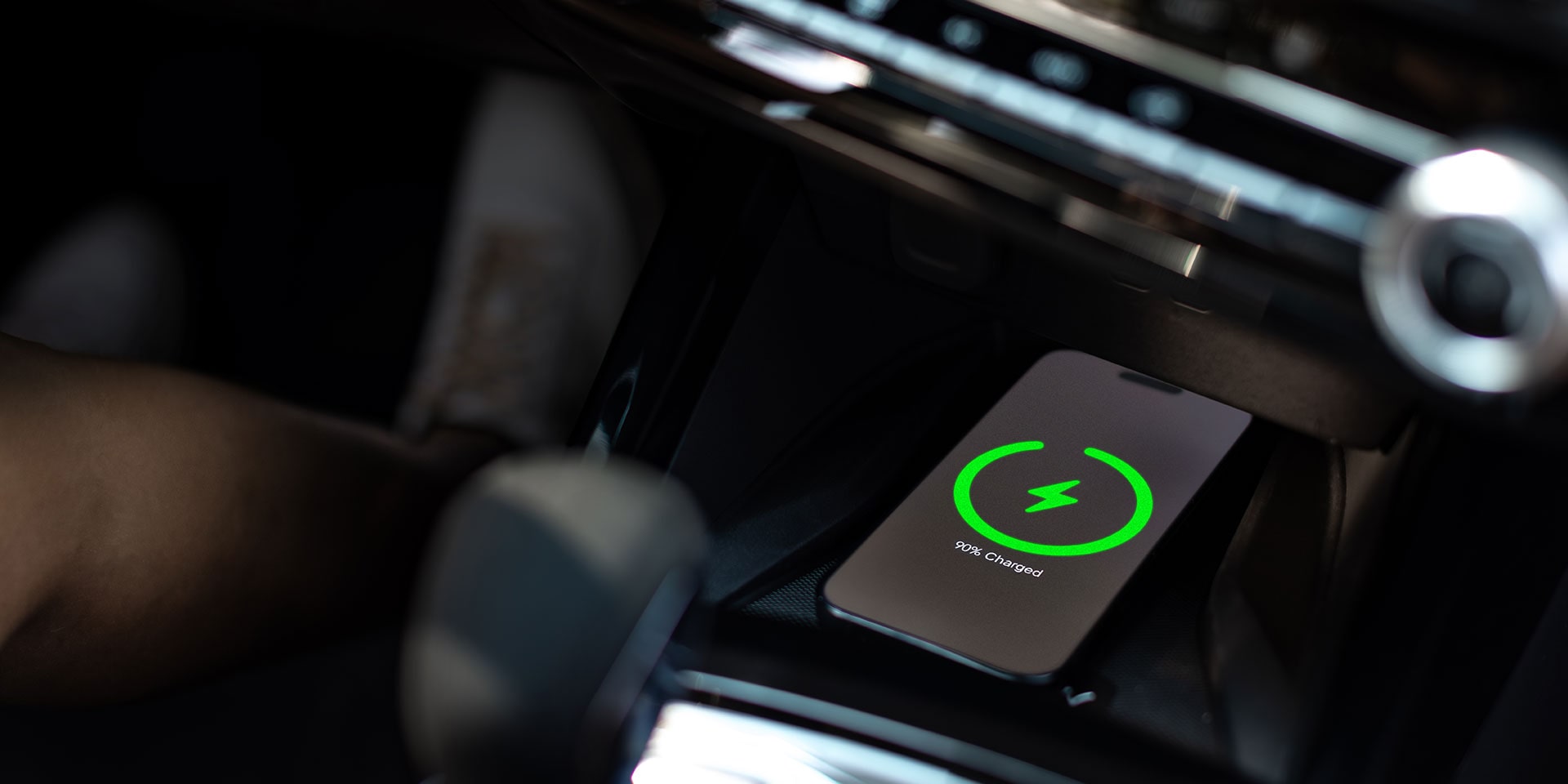 A Smartphone Charging Wirelessly on the Center Console of a Chevy Trax.