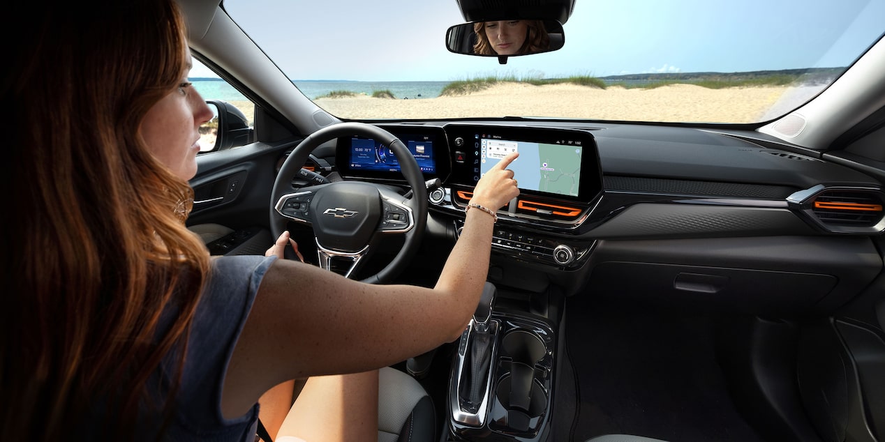 A Wide View of the Chevy Trax Interior Showing the Steering Wheel, Digital Displays, Front Seats, and Center Console.