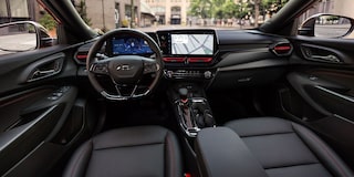 A Wide View of the Chevy Trax Interior Showing the Steering Wheel, Digital Displays, Front Seats, and Center Console.