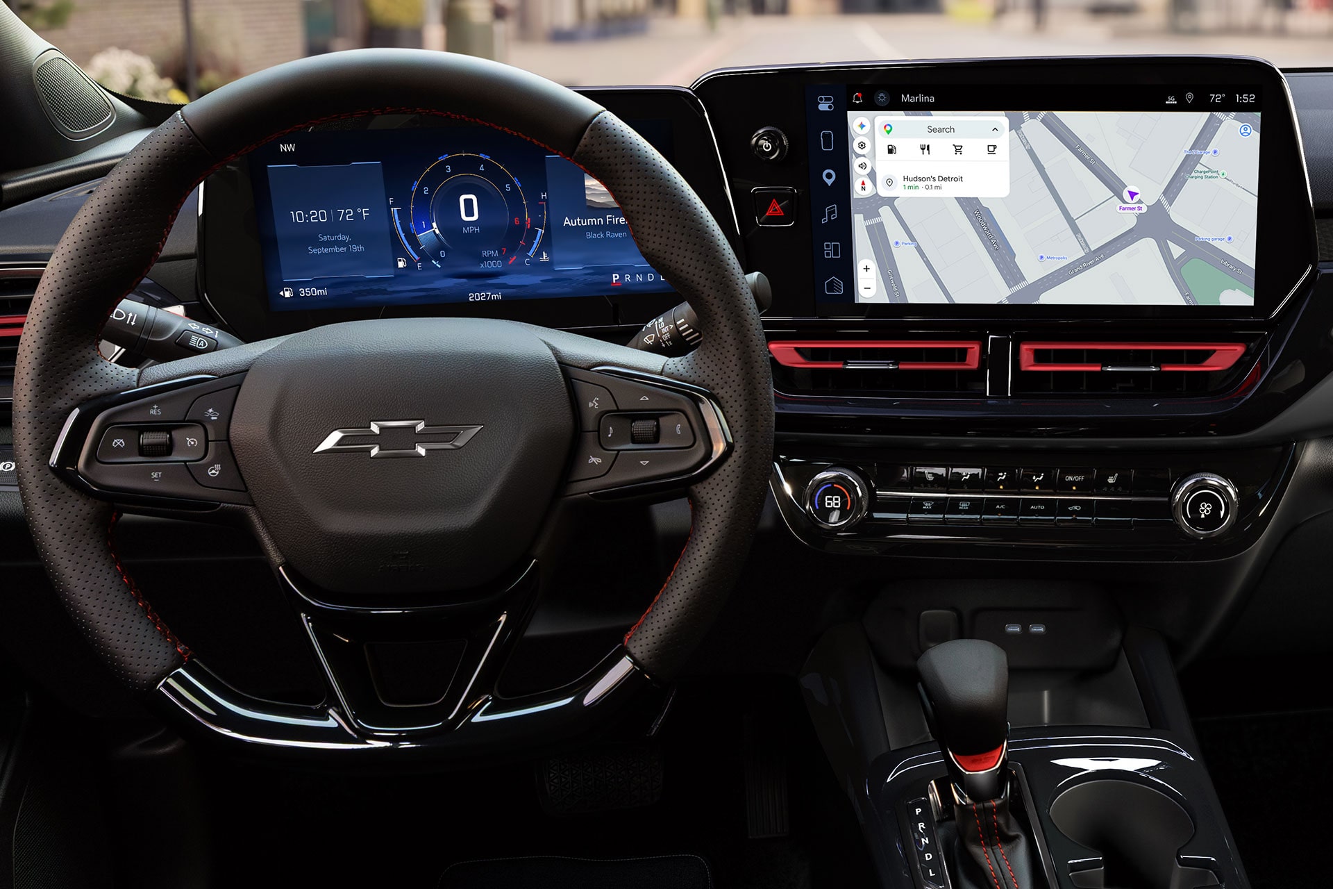 A Wide View of the Chevy Trax Interior Featuring the Steering Wheel, Digital Driver Display, Infotainment Touchscreen, and Front Cabin Controls.