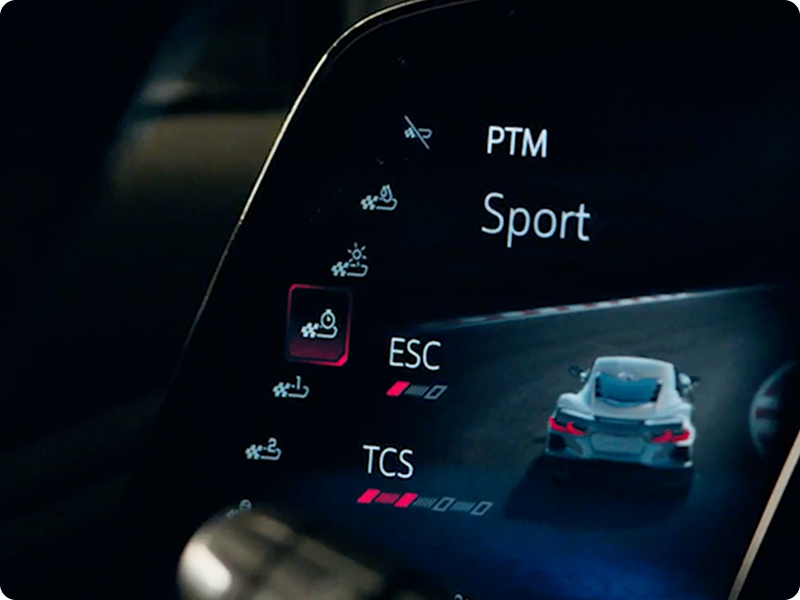 A Close‑Up View of the Digital Display Inside a Chevrolet Corvette Grand Sport Shows Performance Traction Management Settings With Sport Mode Highlighted and Icons for ESC and TCS.