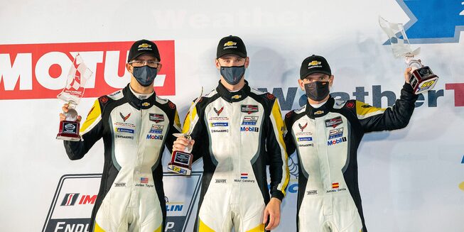 Chevy IMSA Corvette Race Car Drivers with Trophies