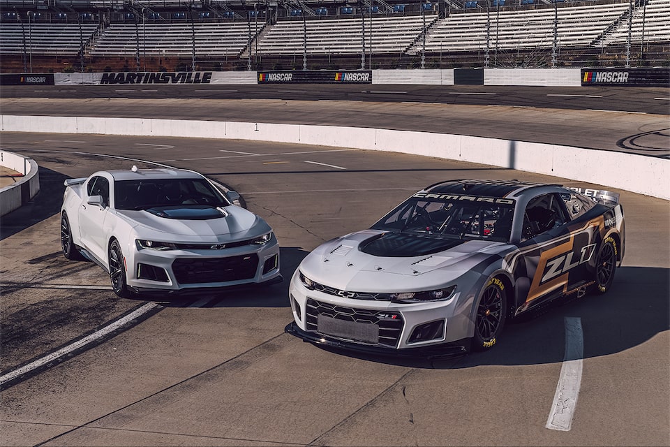 2021 Next Gen Nascar Motorsports: Wideshot of Two Parked Racecars on Racetrack