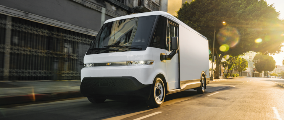 A BrightDrop Van Driving Through City Streets