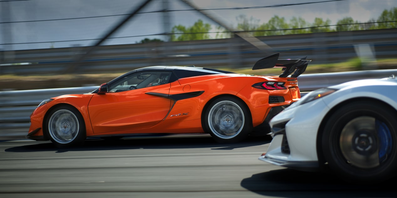 Profile View of a Red Chevy Corvette Speeding Down a Track Ahead of a Competitor