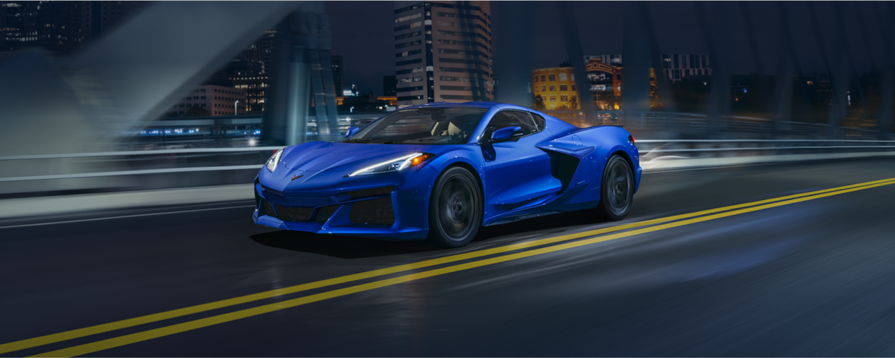 Blue Corvette on Highway Bridge at Night