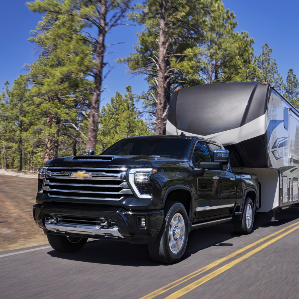 Black Chevrolet Diesel truck towing RV