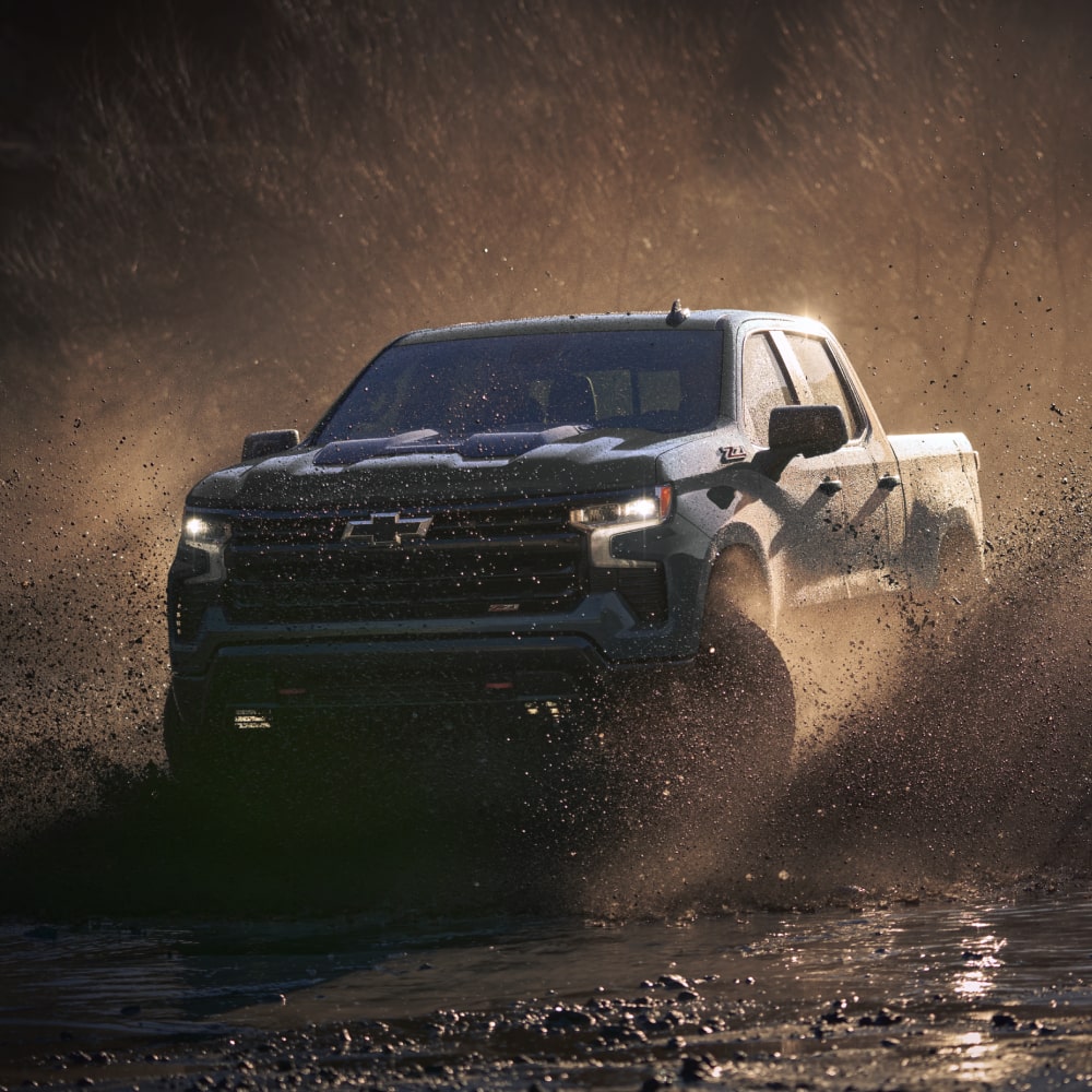 Black Chevrolet Diesel truck towing off road