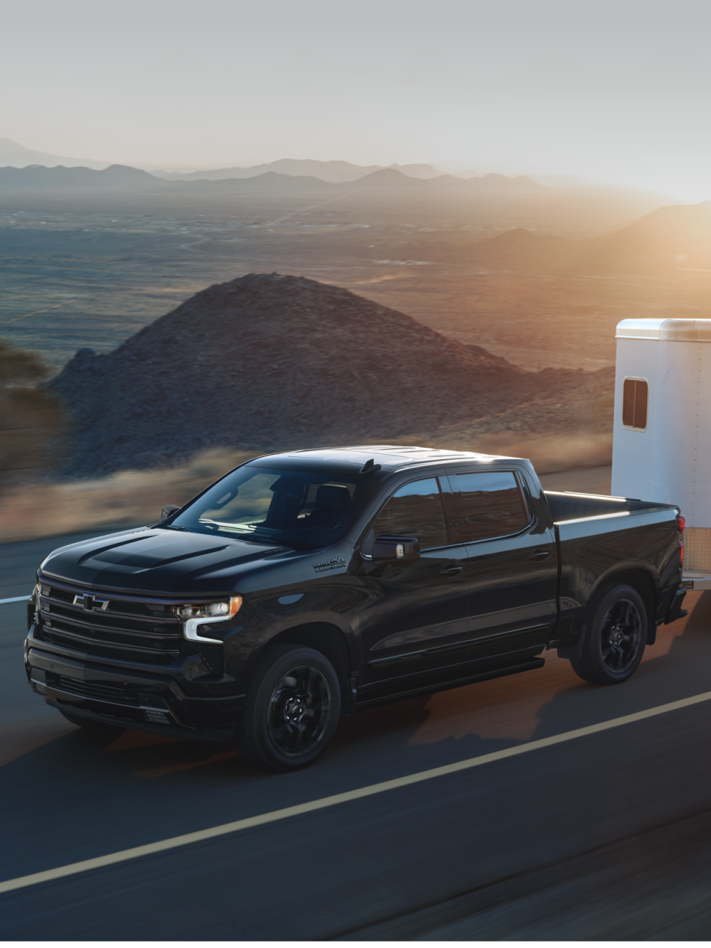 Black Chevrolet Diesel truck towing boat