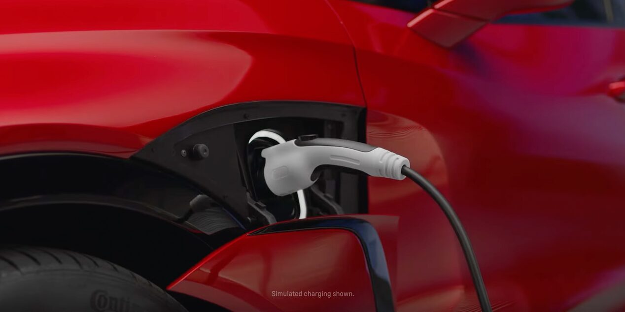 Red Blazer EV Parked In Garage Plugged in to Charger