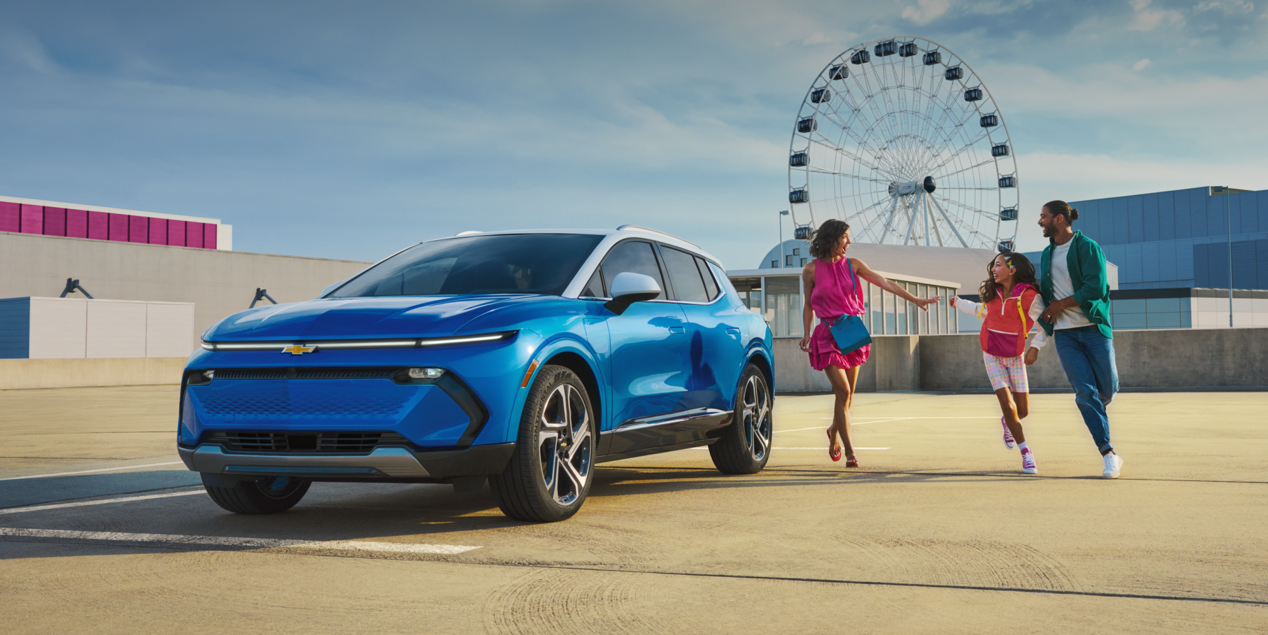 A Family Walking Toward Their Parked 2024 Chevy Equinox EV