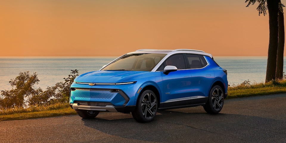 Una Chevy Blazer EV estacionada al atardecer junto a un lago