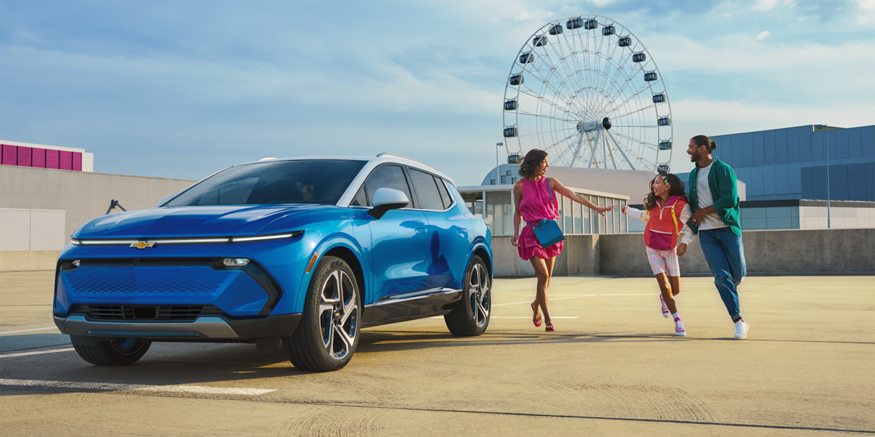 Family Walking Toward Their Chevy Blazer EV in a Fair Parking Lot