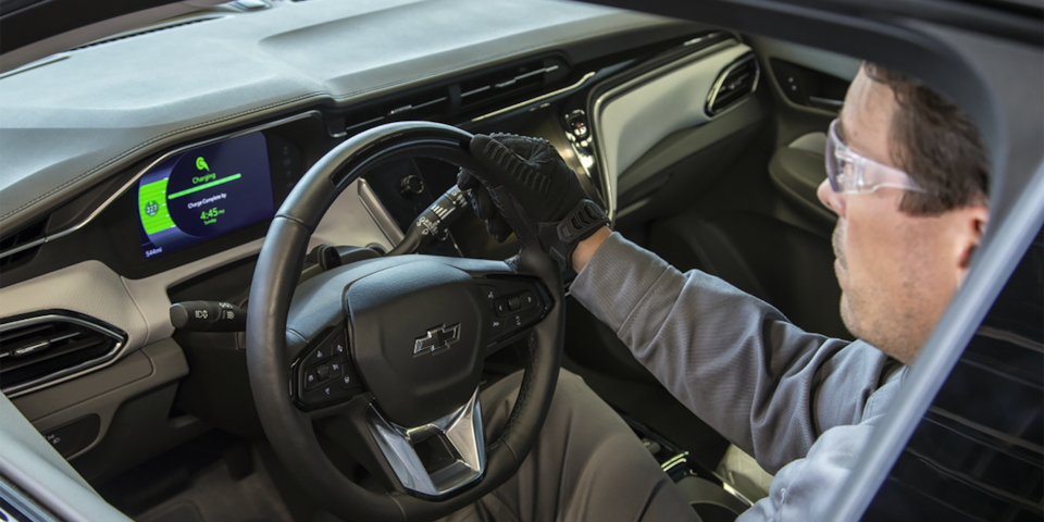 EV Mechanic Working Inside a Chevy EV