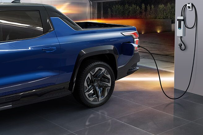 Blue Silverado EV Plugged in to Charger