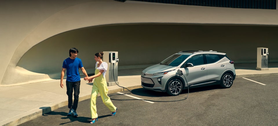 Chevrolet Electric Vehicles: Couple Walking From Charging Bolt EUV