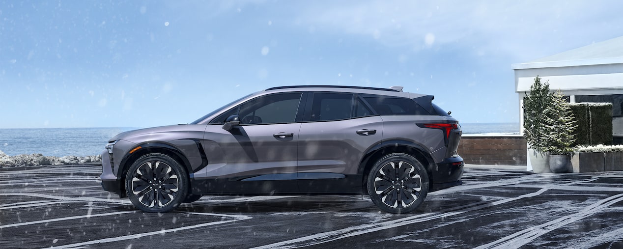Side Profile of a Chevy Blazer EV Parked in a Driveway on a Snowy Day