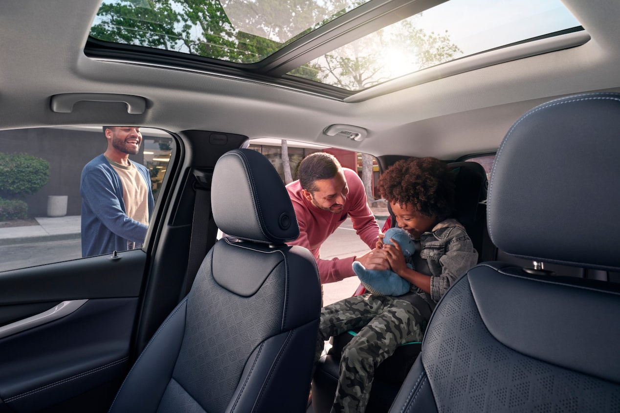 Un padre asegura a su hijo en el asiento dentro de un Chevy EV