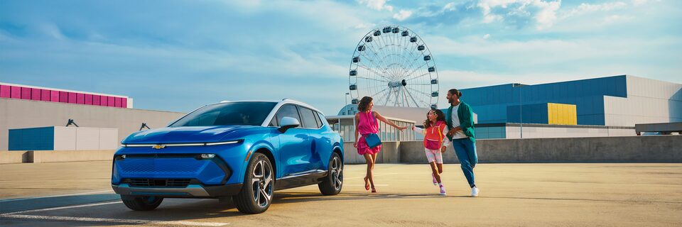 Electric Vehicle FAQs: Family walking next to Blue Blazer EV