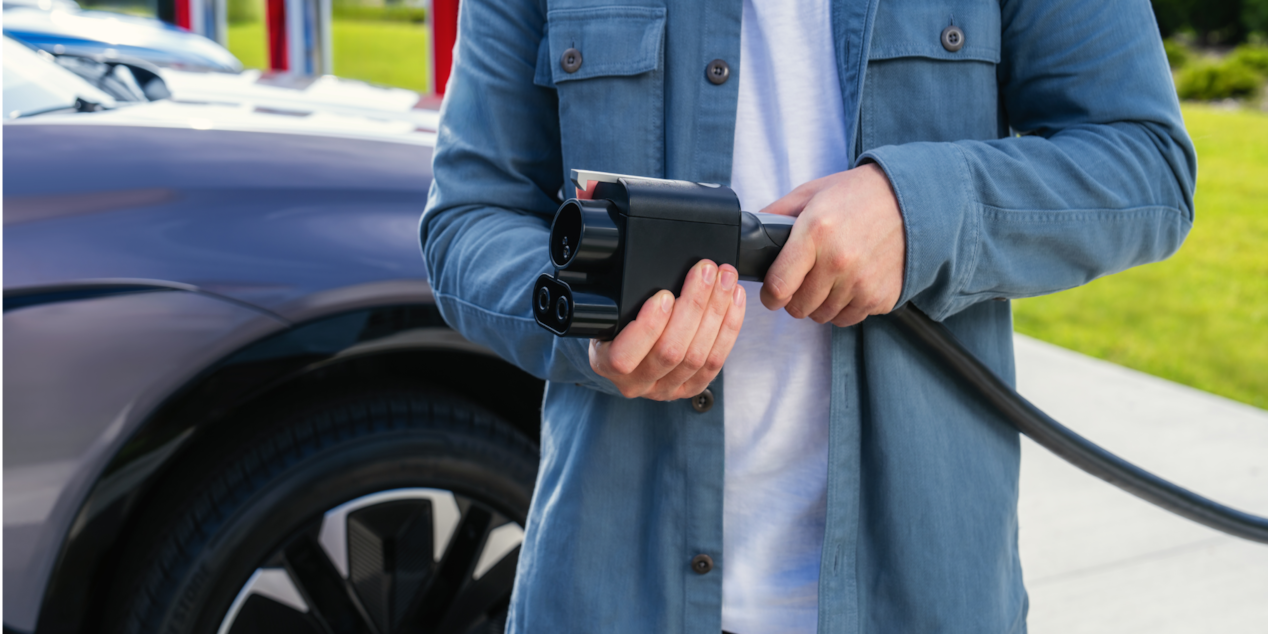 A Man Holding a Chevy EV Charger