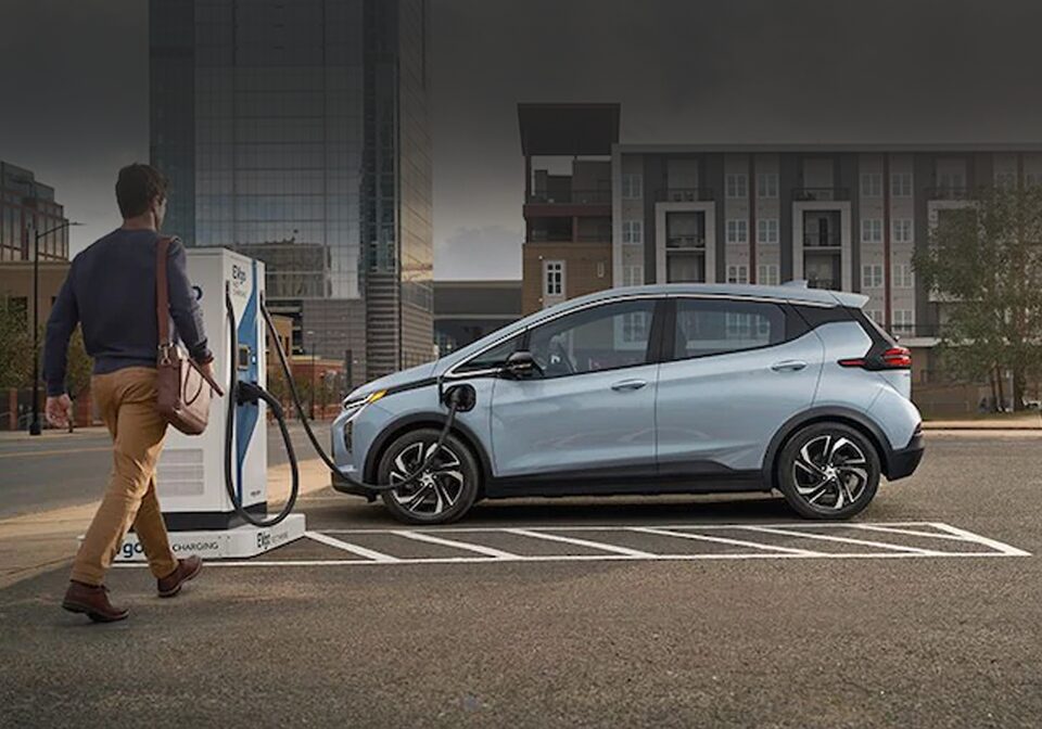 A Chevy Bolt EV Owner Walking up to Their Charging Car
