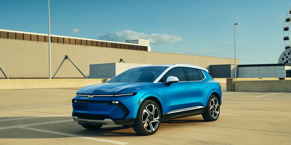 The Equinox EV Parked On Top Of A Parking Structure