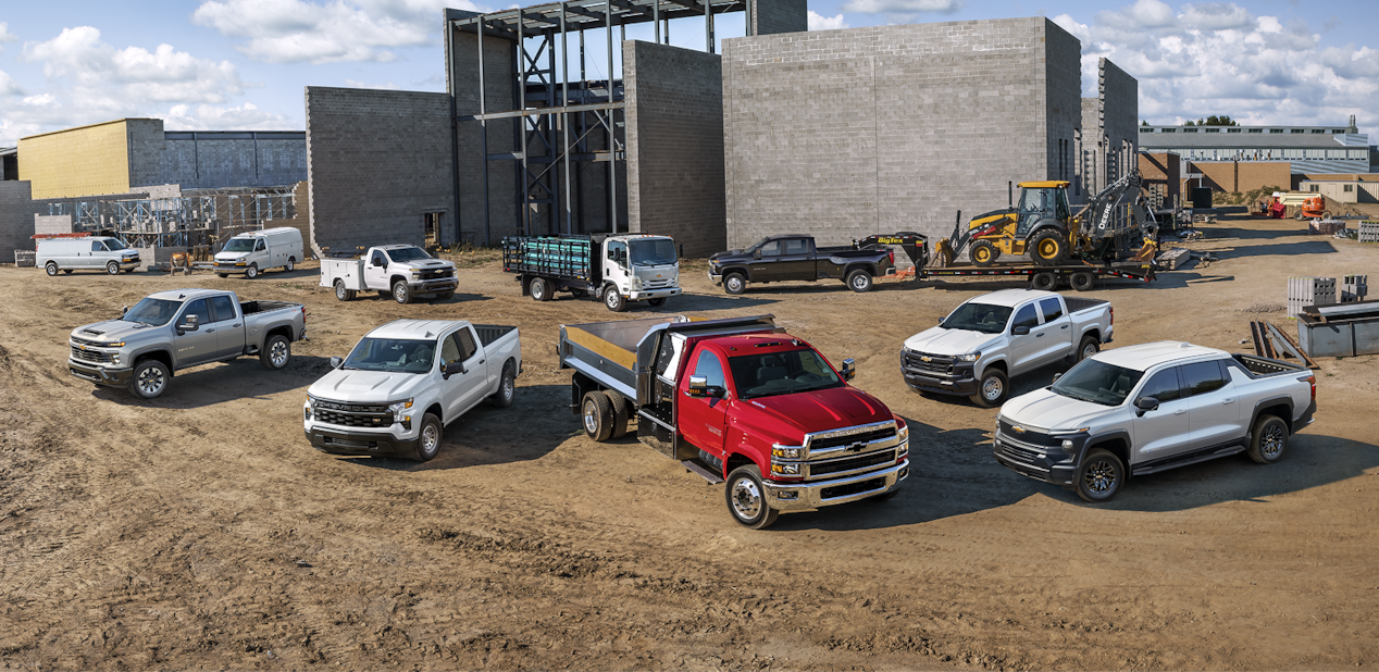 Gama de vehículos de flota Chevy estacionados en una obra en construcción