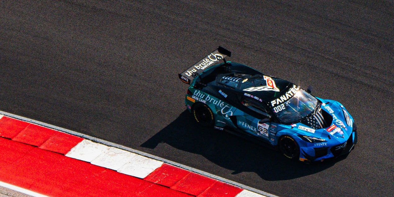 Top-Down View of a Blue Chevy Corvette Racing Down the Track