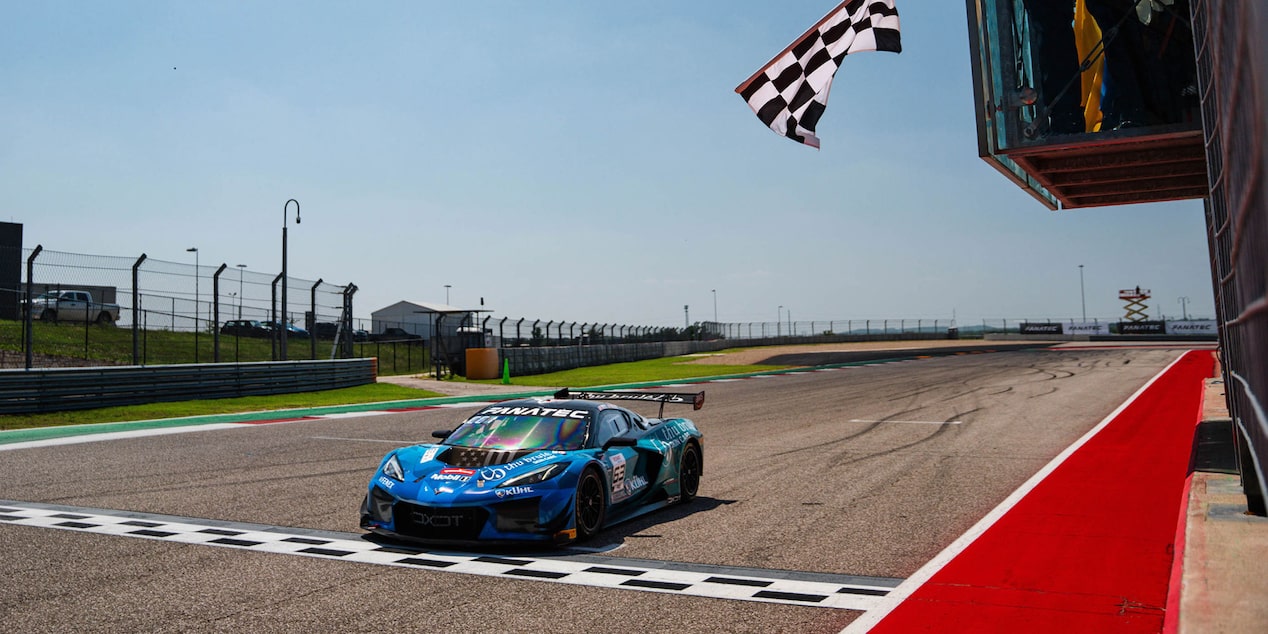 Front Angle View of a Blue Chevy Corvette About to Cross the Finish Line