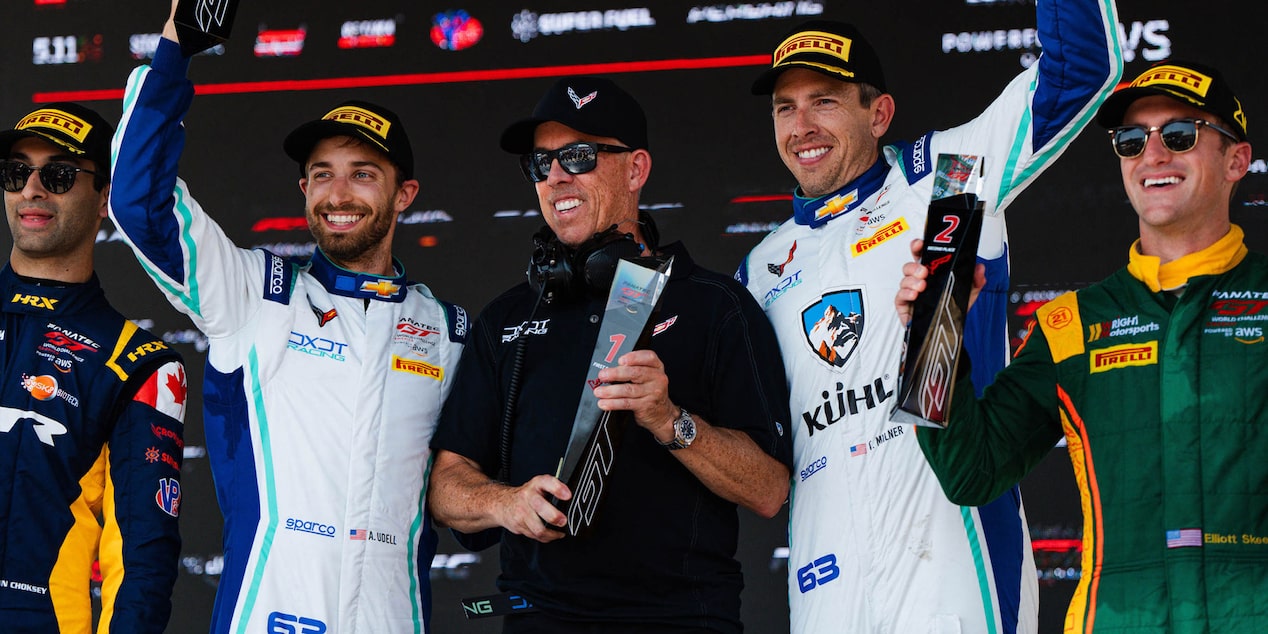 Two Racers Raising Their Hands up for Winning the Race with People Around Them