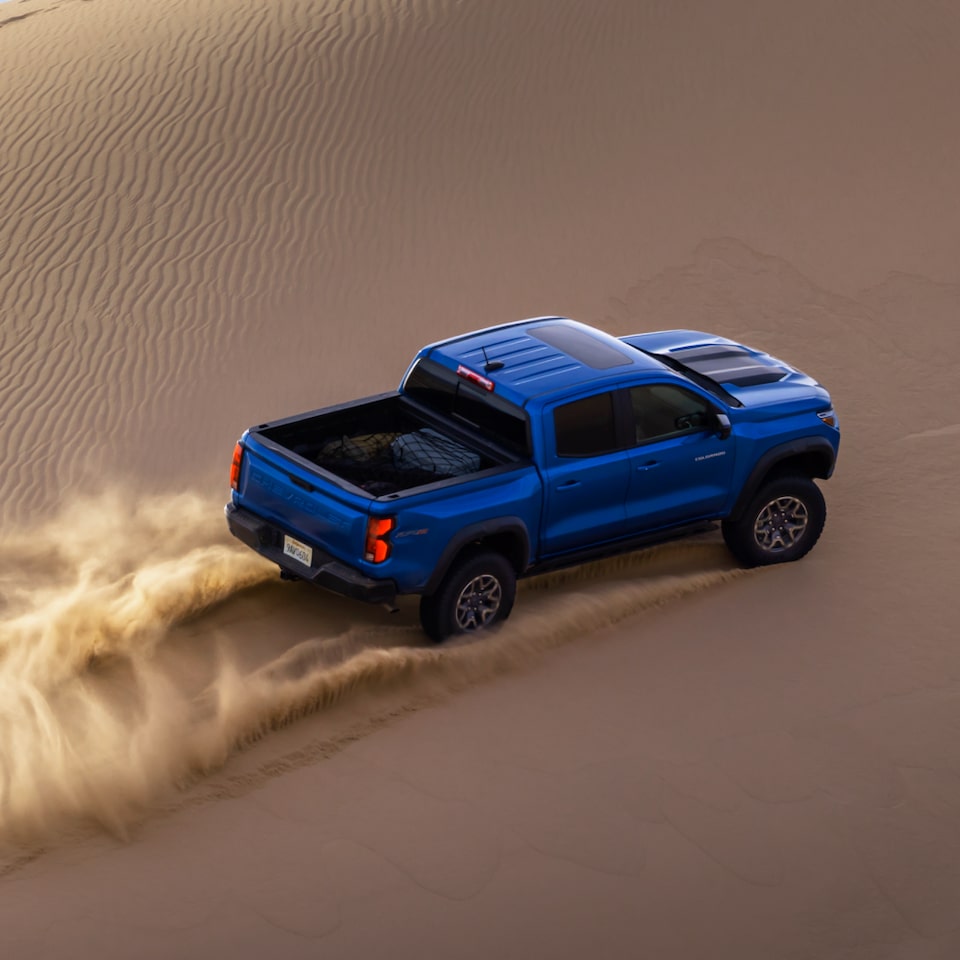 Blue ZR2 Tearing Through Sandy Offroad Terrain