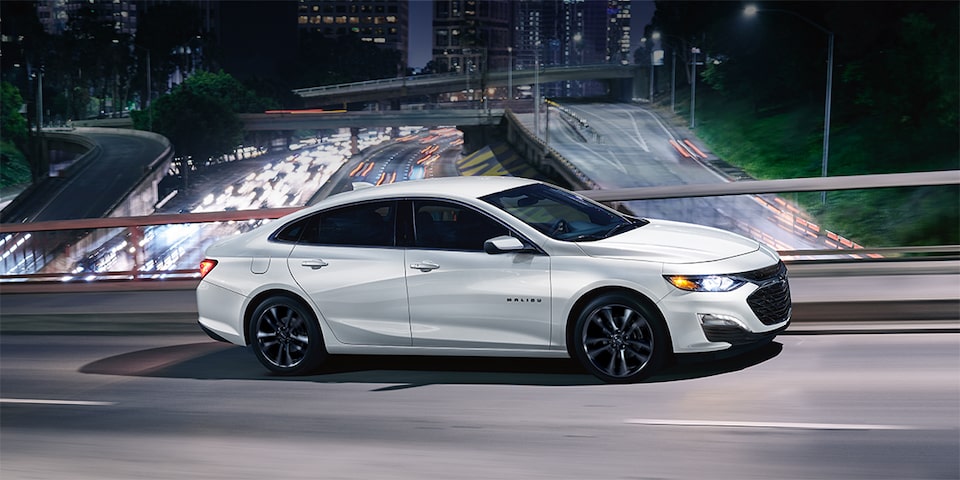The Summit White Chevy Malibu Driving Ferociously Fast on The Expressway 