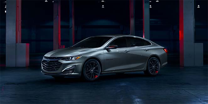 Redline Edition Chevy Malibu's Taillamps Casting a Red Aura as it Sits in a Garage
