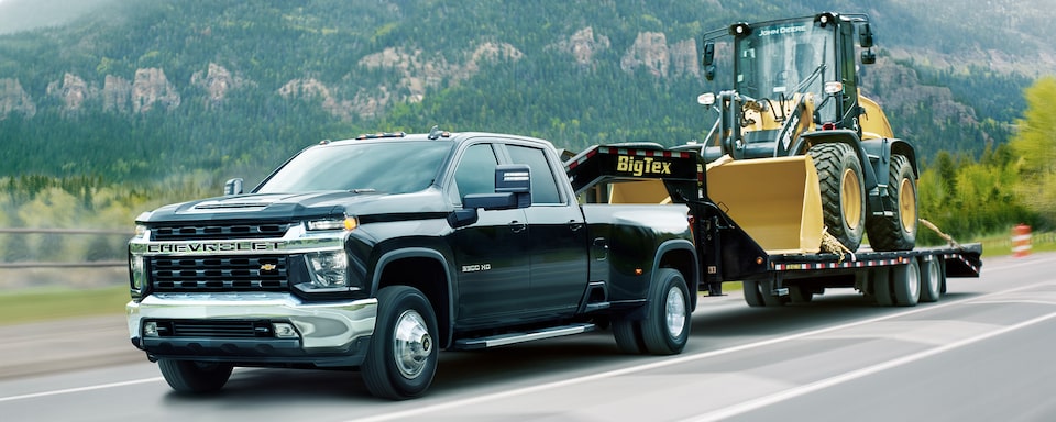 Navy Blue Chevy Commercial Silverado HD Towing Heavy Machinery