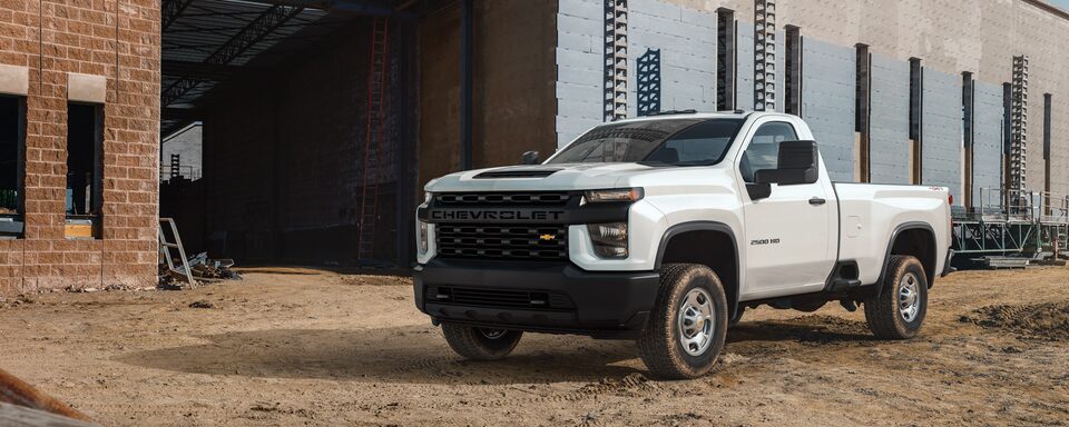 White Chevy Commercial Silverado HD parked on a Construction Site