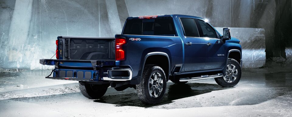 Blue Commercial Chevy Silverado HD Using the Multi-Flex Tailgate to transport PVC