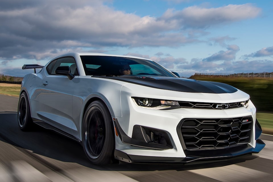 White Camaro coupe driving on road