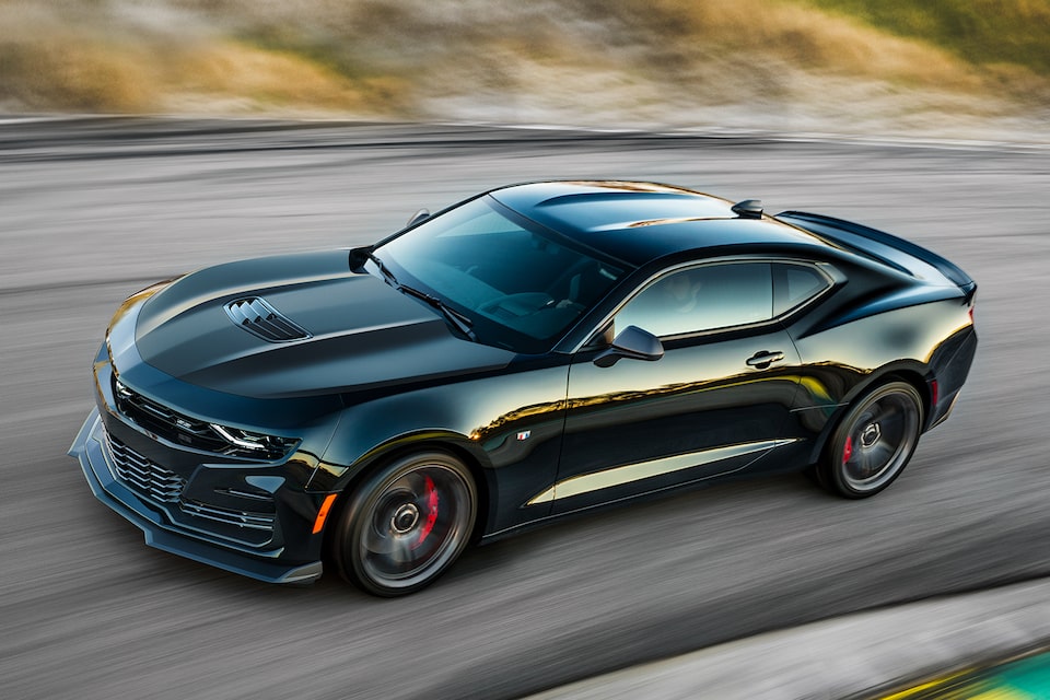 All black Camaro drives on road