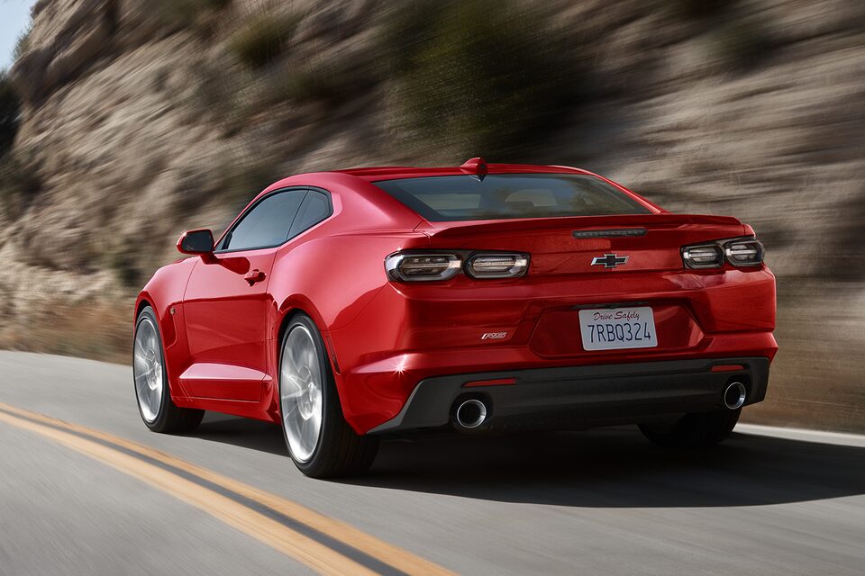 Red Camaro cruises through the mountains