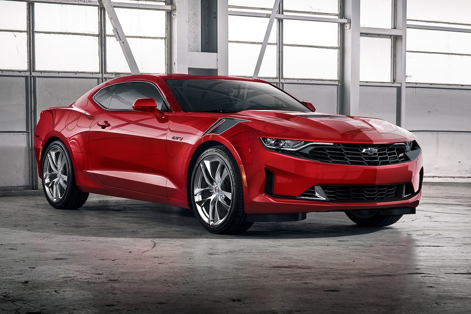 Red Camaro displayed in a garage