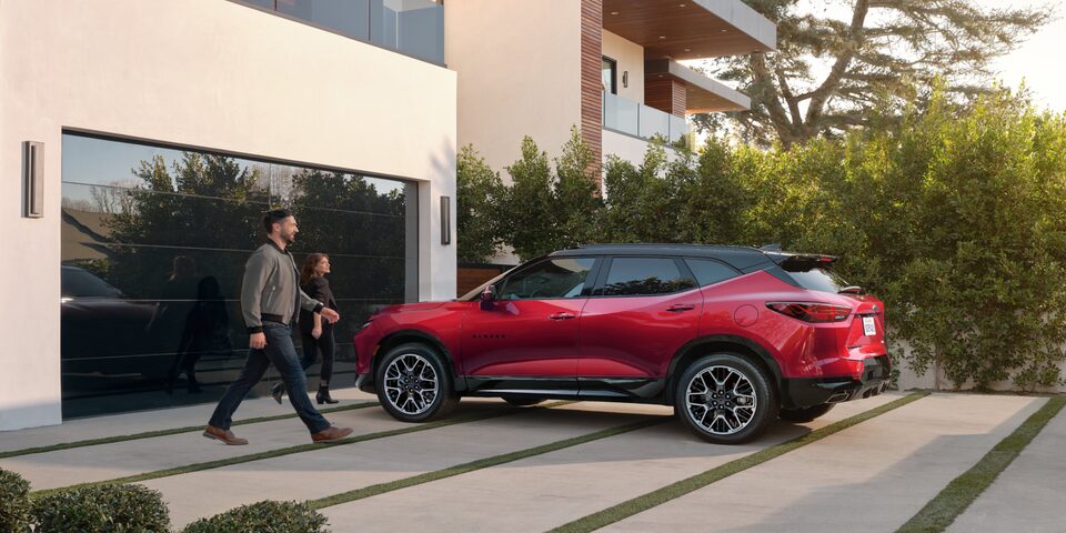 A Couple Leaving Their Luxurious Home Approach Their Chevy Blazer to go for a Drive