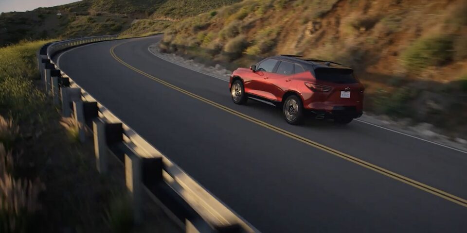 The Blazer Hugging a Mountain Road Curve while Driving on an Open Roadway