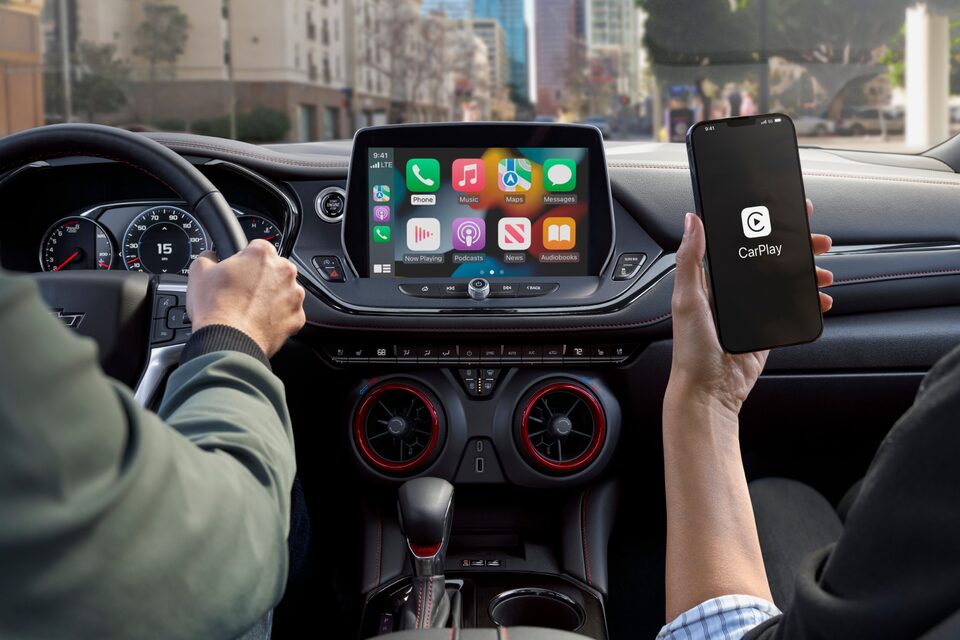 A Woman Uses Apple Car Play to Seamlessly Control her Infotainment System of the Chevy Blazer