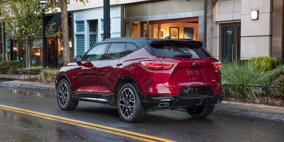 The 2023 Radiant Red Tintcoat Chevy Blazer Cruising Through a Modern Neighborhood