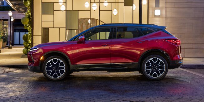 The 2023 Radiant Red Tintcoat Chevy Blazer Parked at Night in the City