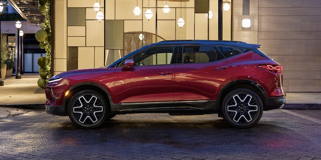 The 2023 Radiant Red Tintcoat Chevy Blazer Parked at Night in the City