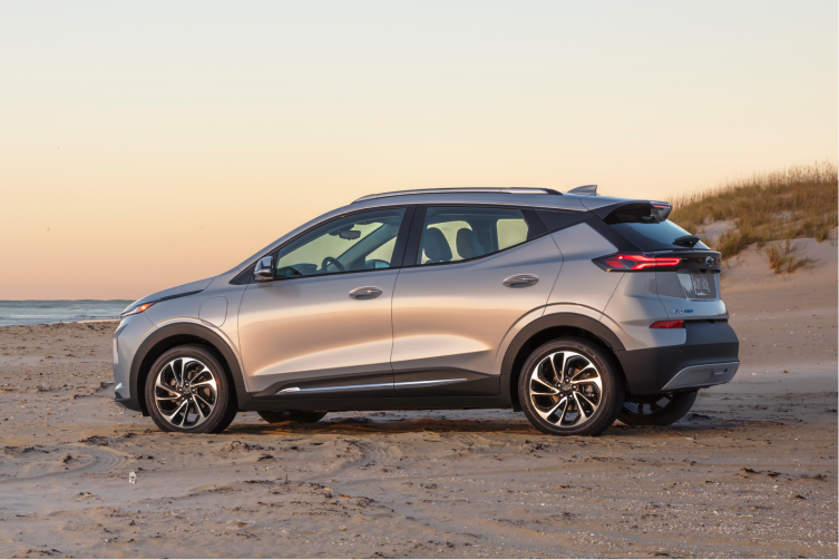  Driver's Side Rear 3/4 Shot of Silver 2023 Bolt EUV on Sandy Beach