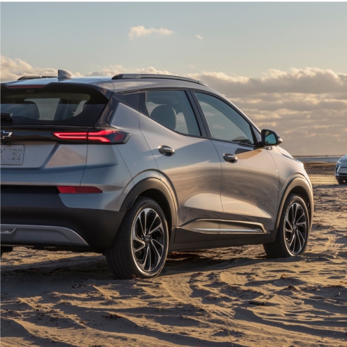 Rear 3/4 Shot of Silver 2023 Bolt EUV Parked on Sandy Beach