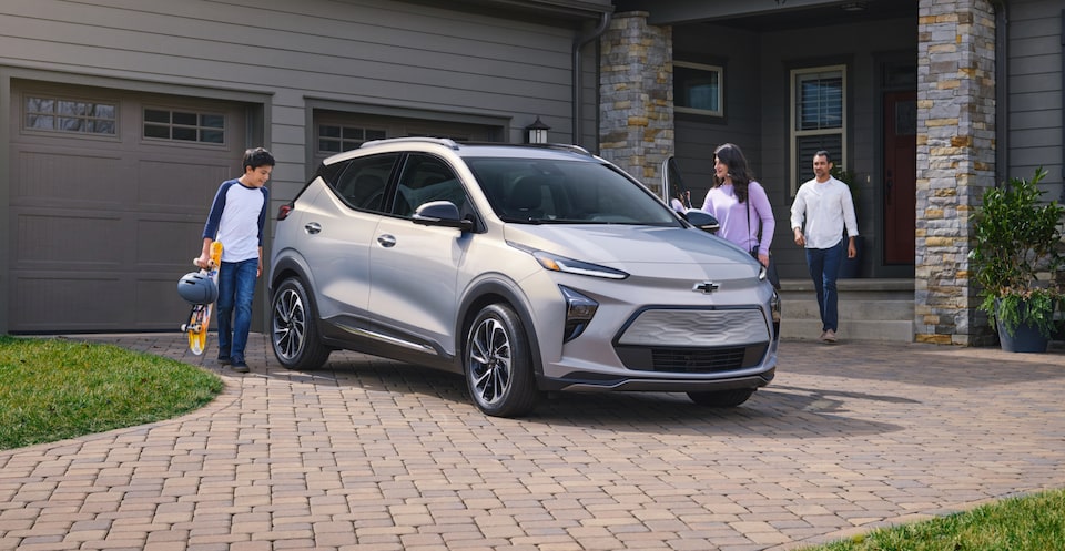 Family Walking to Enter 2023 Bolt EUV Parked in Driveway