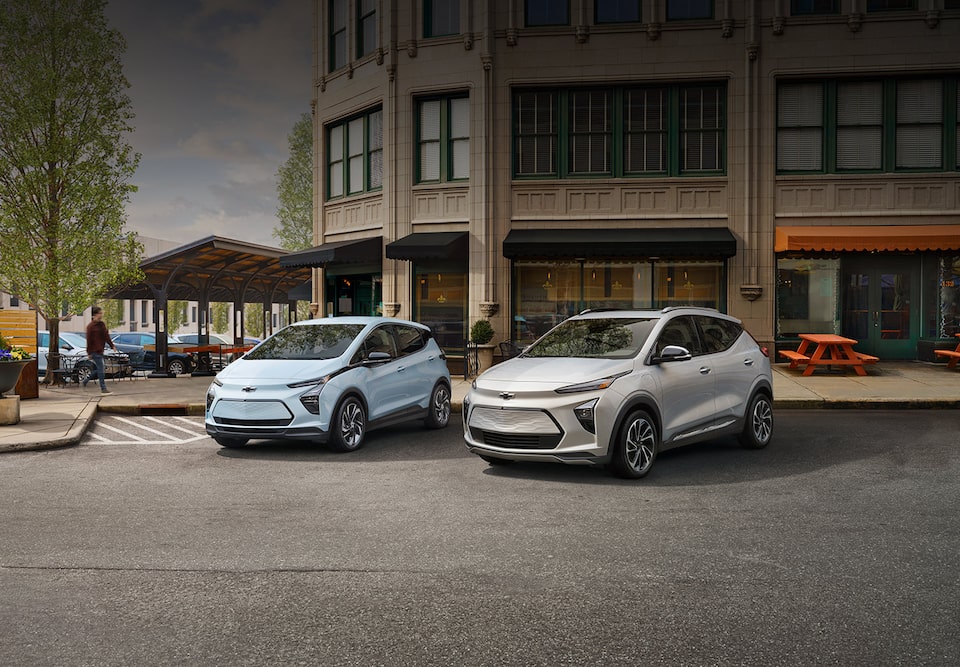 Pack shot of 2023 Bolt EV and EUV Vehicles Parked on Town Street